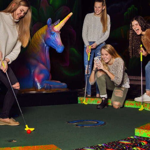 millenial girls playing glow golf fleetway